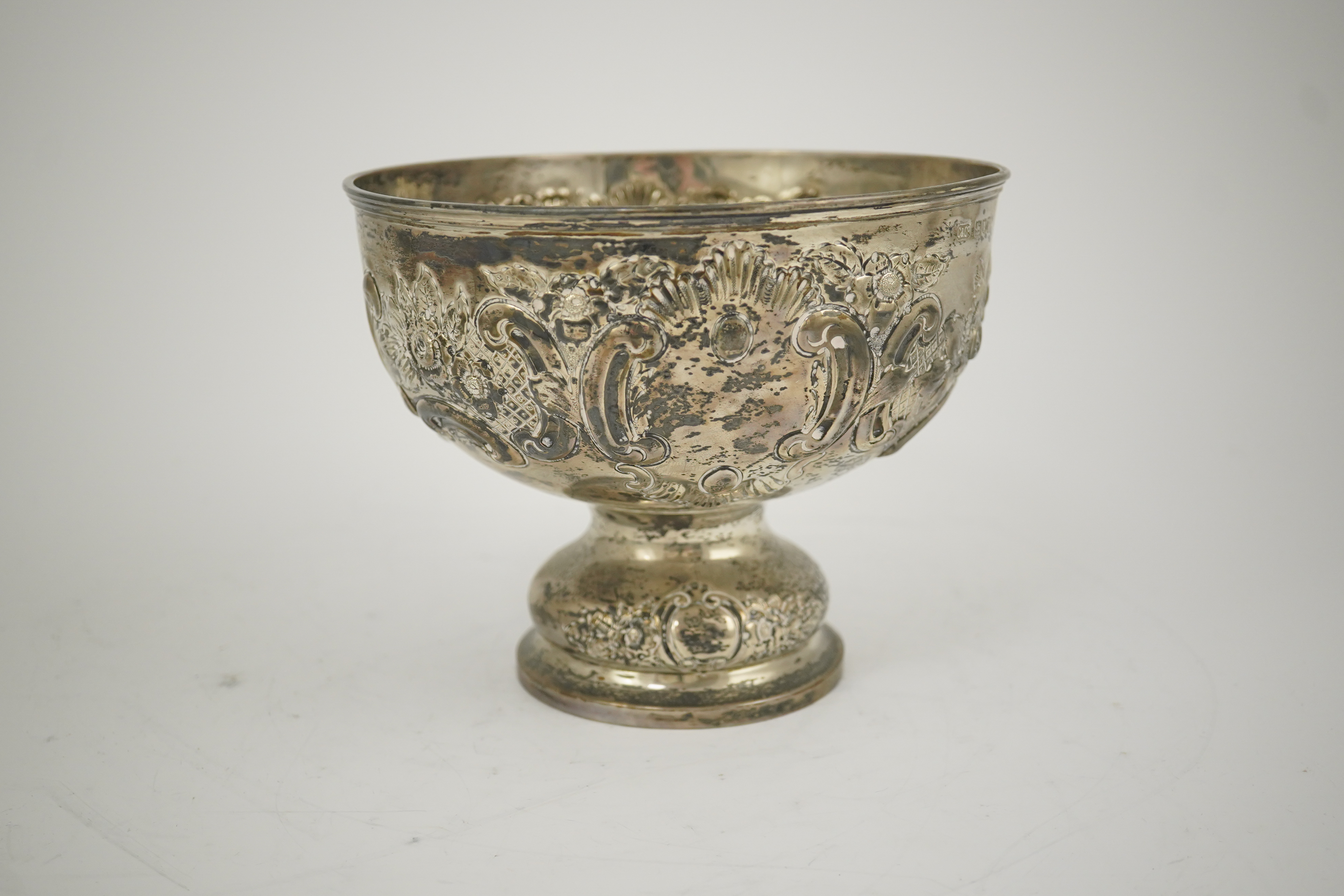 A George V repousse silver pedestal rose bowl, by Carrington & Co